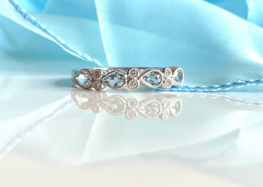 A tear drop design white gold aquamarine and diamond eternity ring