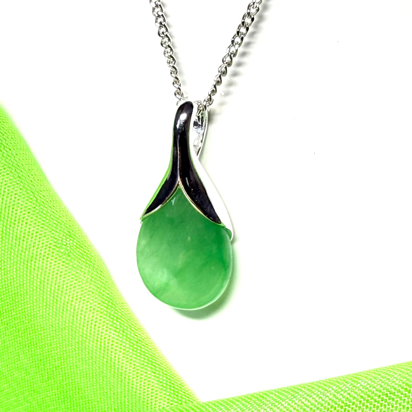 Real green jade necklace in a teardrop or pear shaped including a solid chain