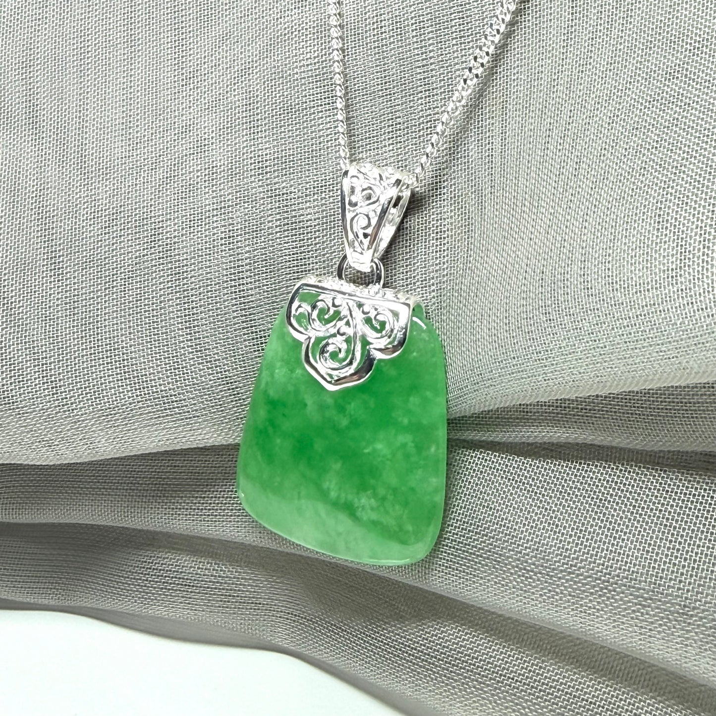 A beautiful and stunning real green jade necklace large pendant that is cushion shape