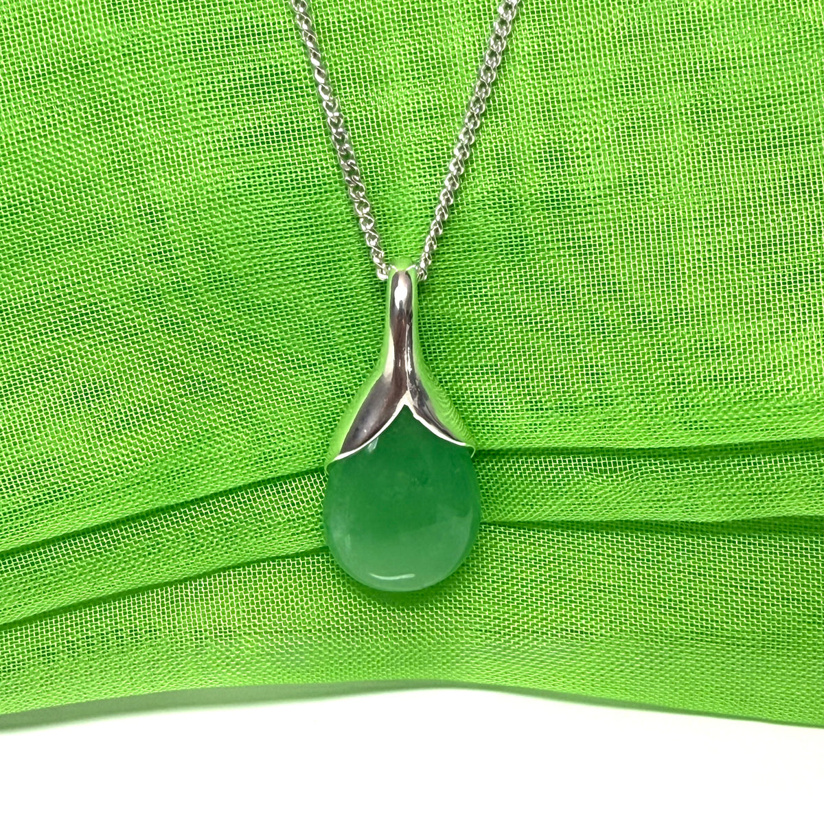 A beautiful and stunning real green jade pendant necklace in a teardrop shaped or pear shaped
