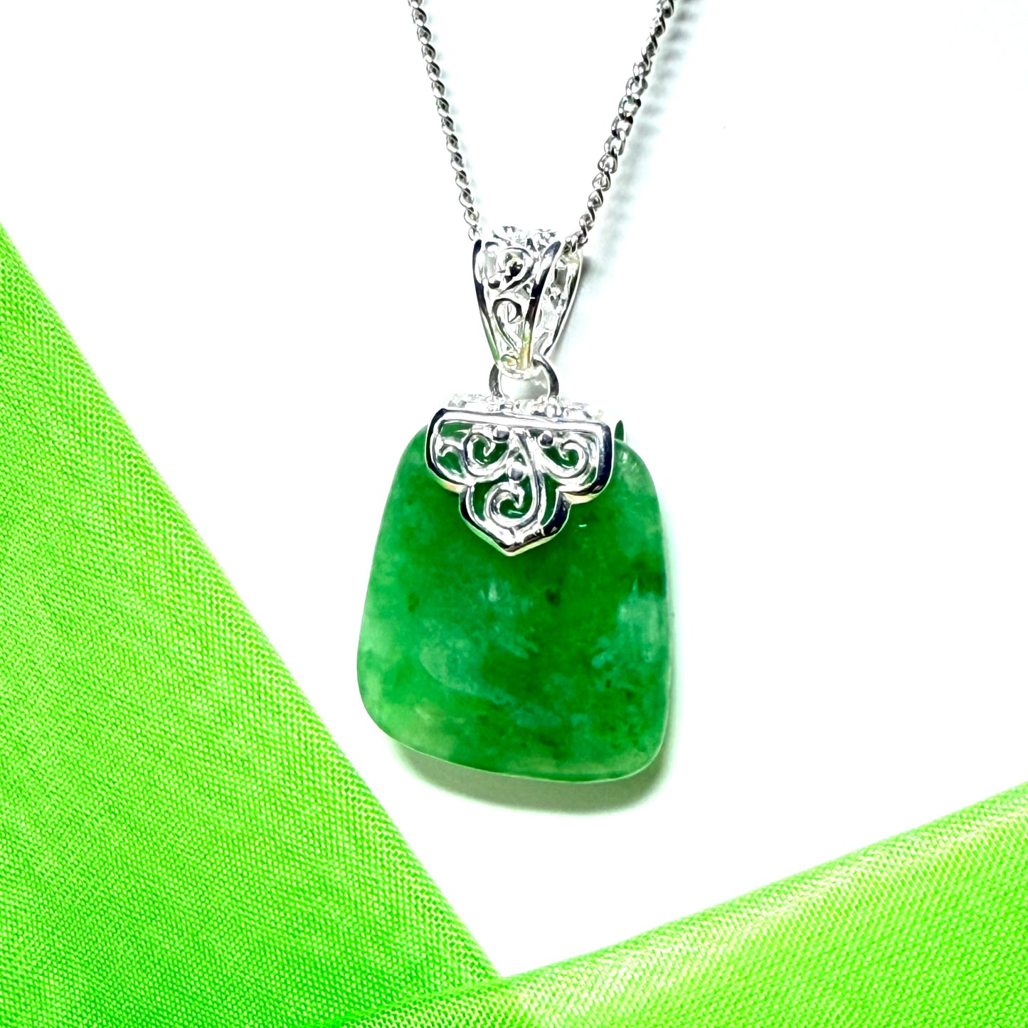 A beautiful and timeless real green jade necklace large cushion shaped with a chain included