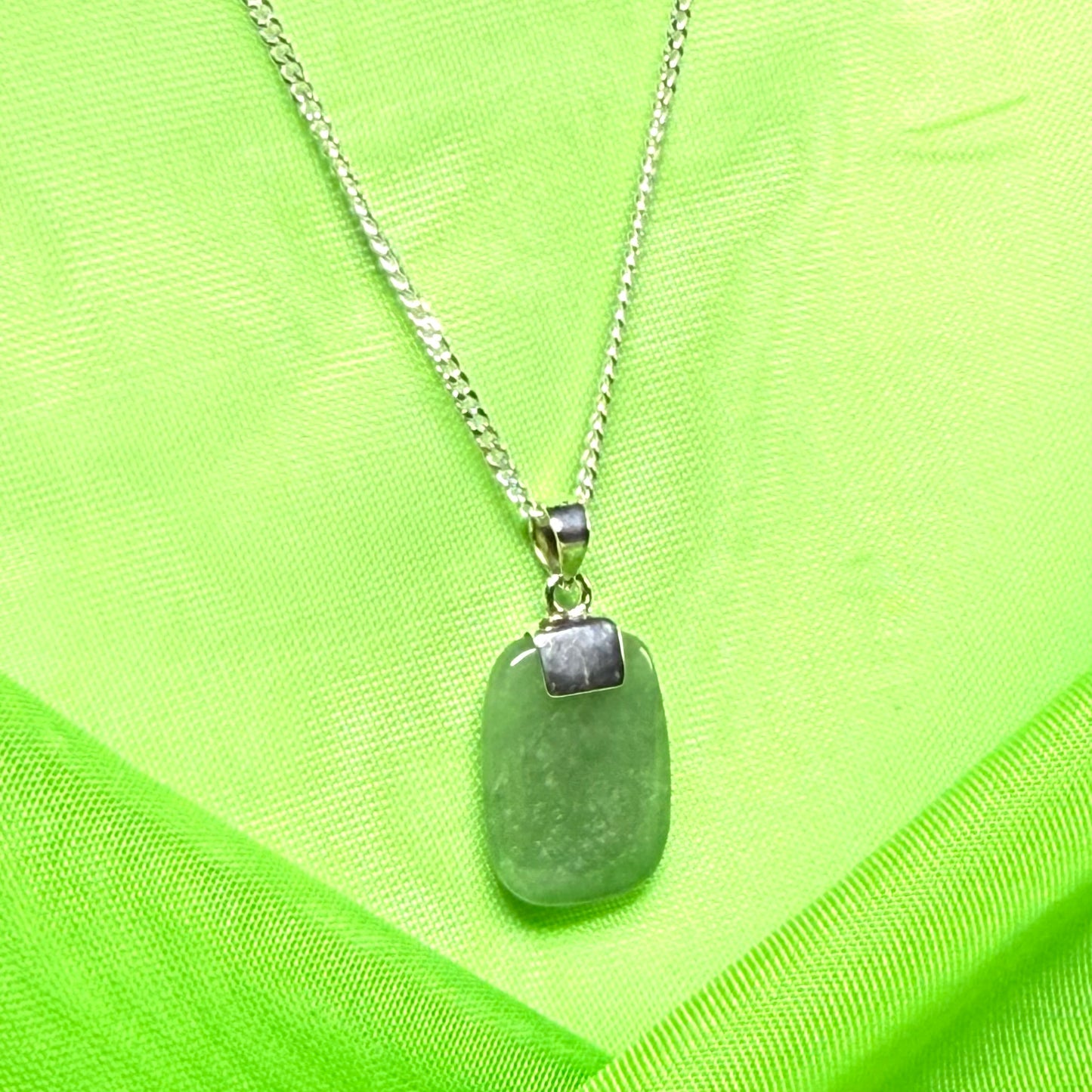 A cushion shaped silver real green jade necklace pendant