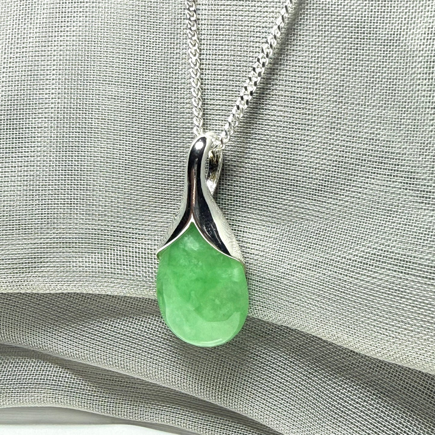 A gorgeous real green jade necklace teardrop with a pear shaped pendant to it