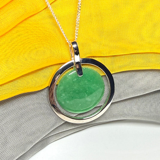 A large sterling silver green real jade necklace halo style, a traditionally designed round pendant