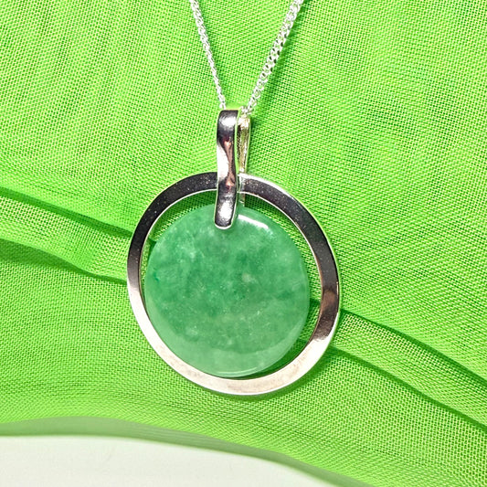 A large sterling silver round shaped green real jade necklace halo style, a traditionally designed pendant