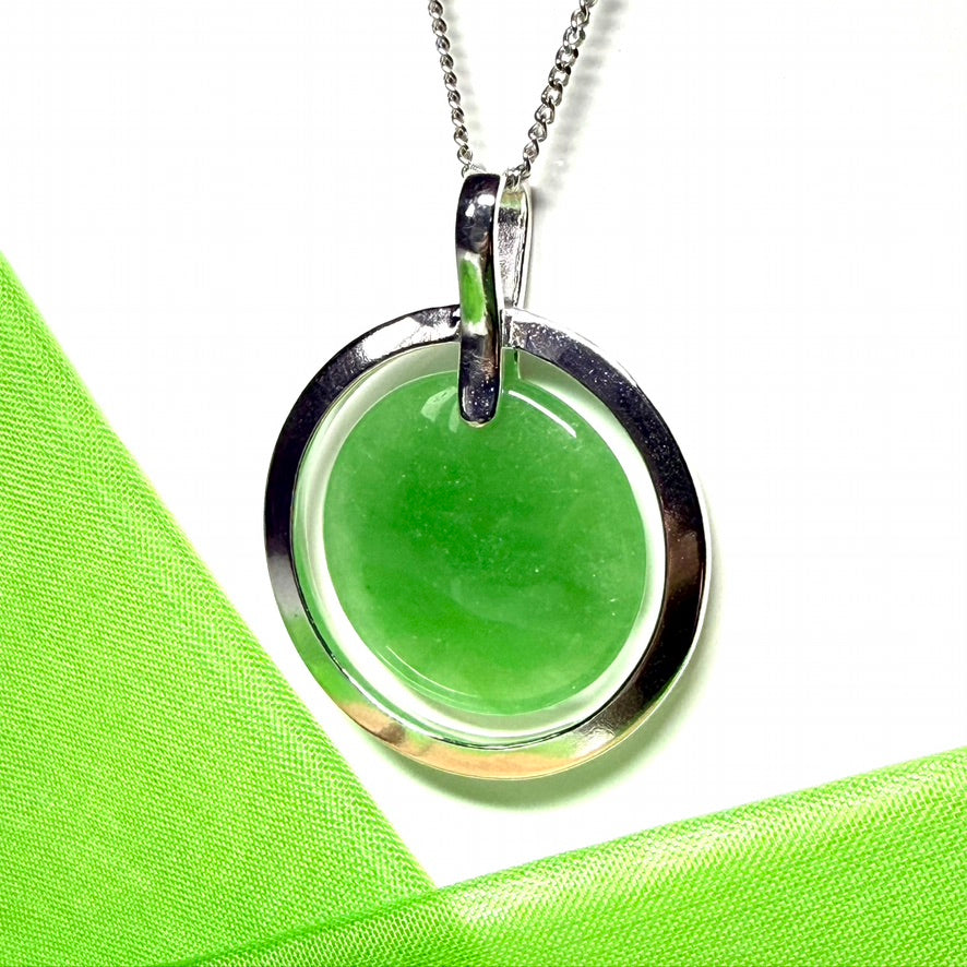 A large sterling silver round shaped green real jade necklace halo styled pendant with a chain included with it