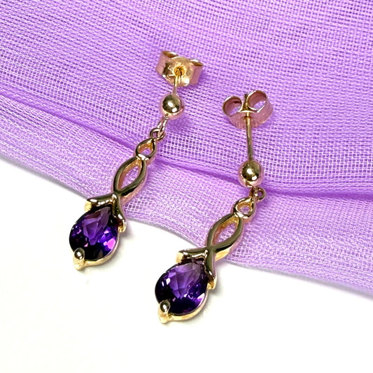 A pair of real amethyst drop earrings pear shaped yellow gold