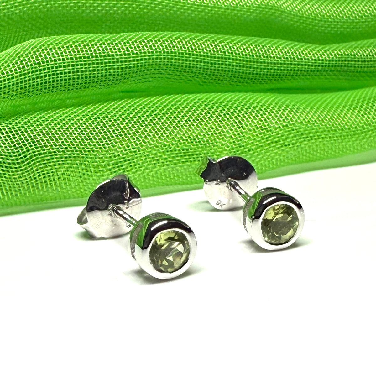 Pair of real green peridot earrings round white gold stud smooth rubbed over setting