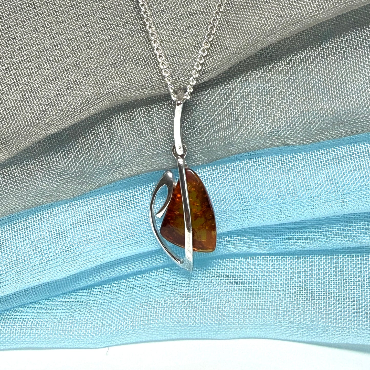 A real amber necklace sterling silver fancy open triangle shaped amber pendant with chain