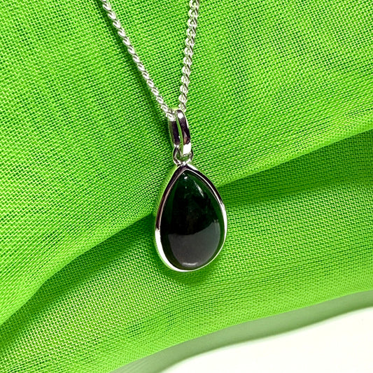 A real dark green jade necklace in a tear drop or pear shape smooth rub over setting