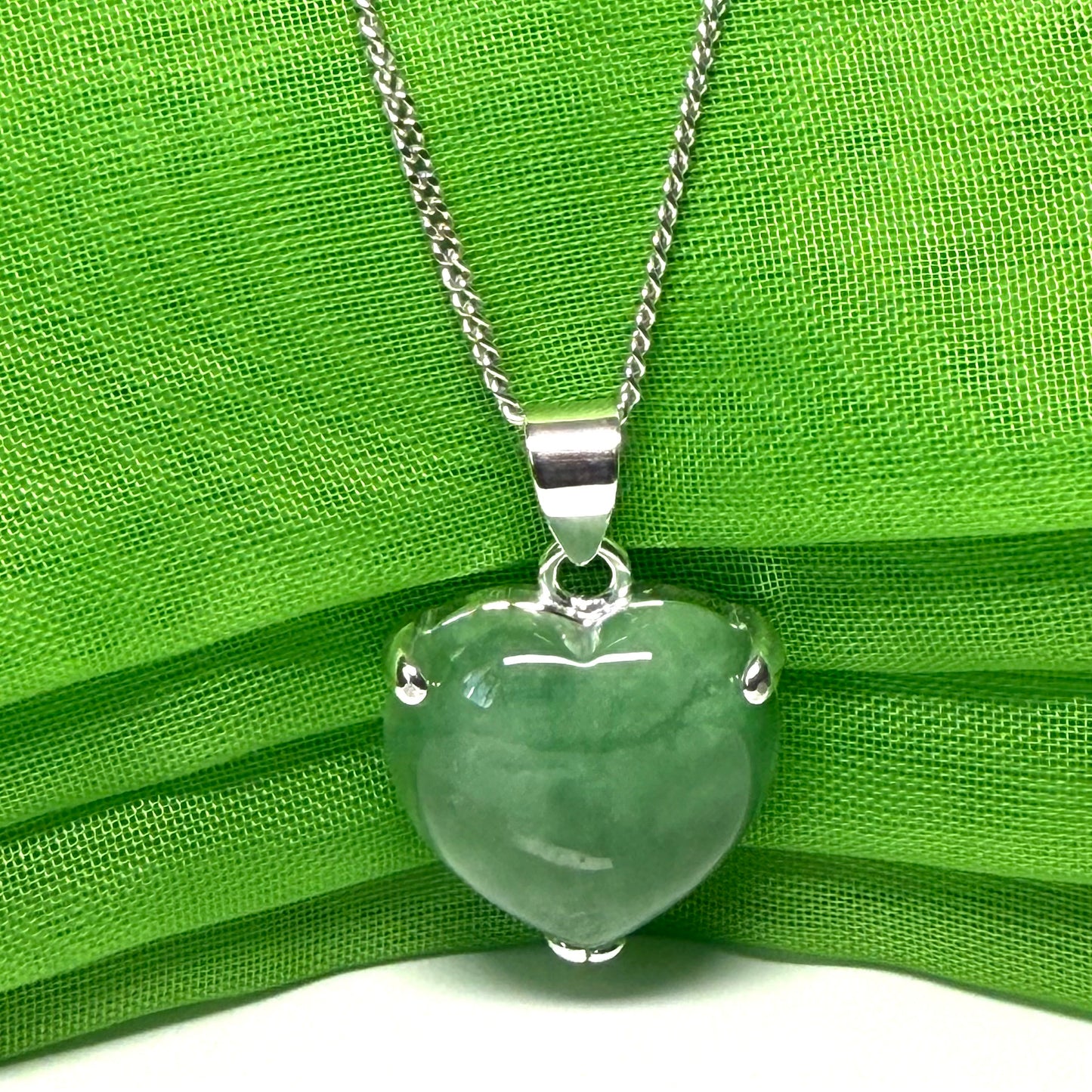 A real dark green jade pendant necklace heart shape sterling silver with a chain included