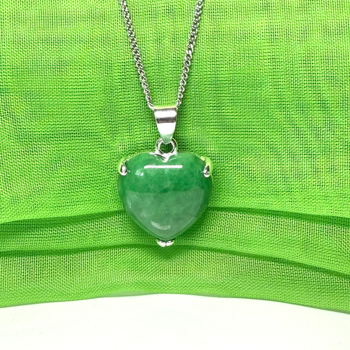 A real dark green jade pendant necklace heart shaped sterling silver setting, simply beautiful