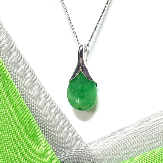 A real green jade necklace having a tear drop or pear shape, an outstanding designed pendant