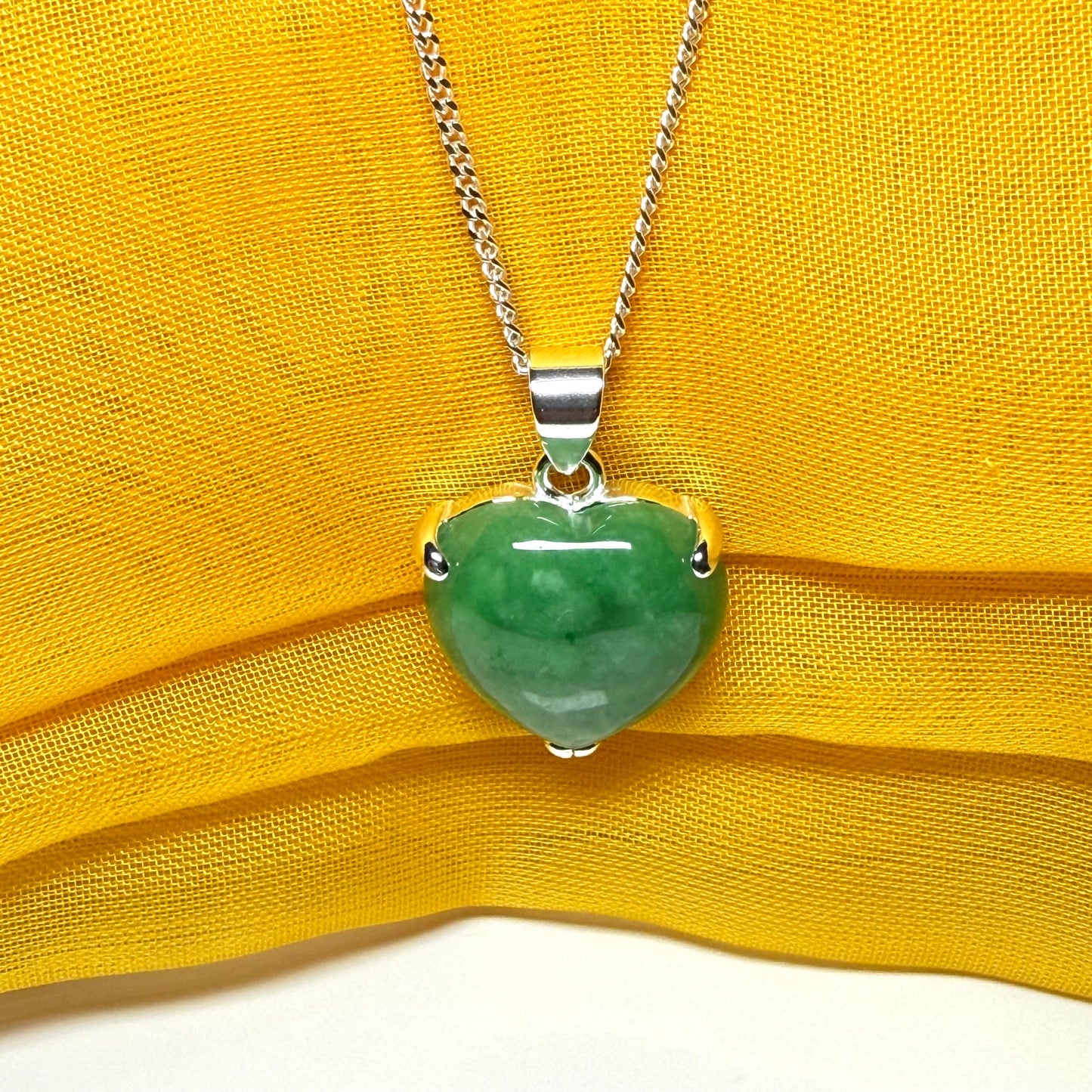 A real green jade necklace heart shape sterling silver pendant including chain
