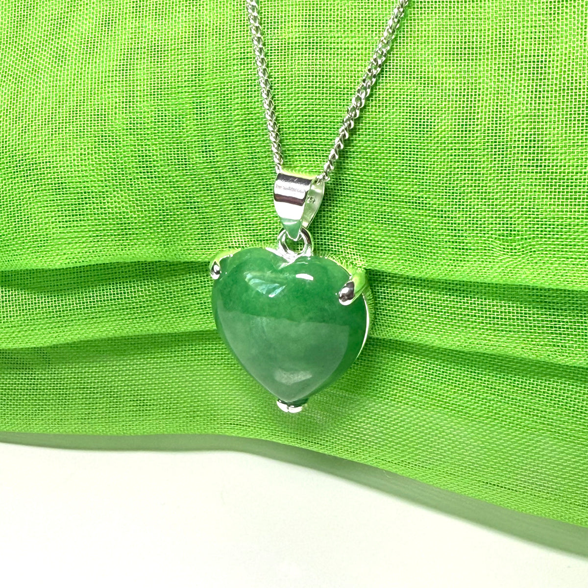 A real green jade necklace heart shape sterling silver pendant