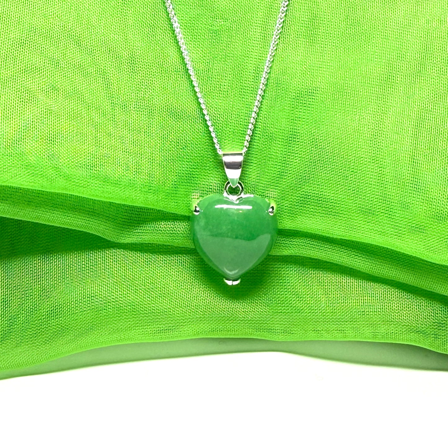 A real green jade pendant heart shaped sterling silver, a traditionally designed necklace