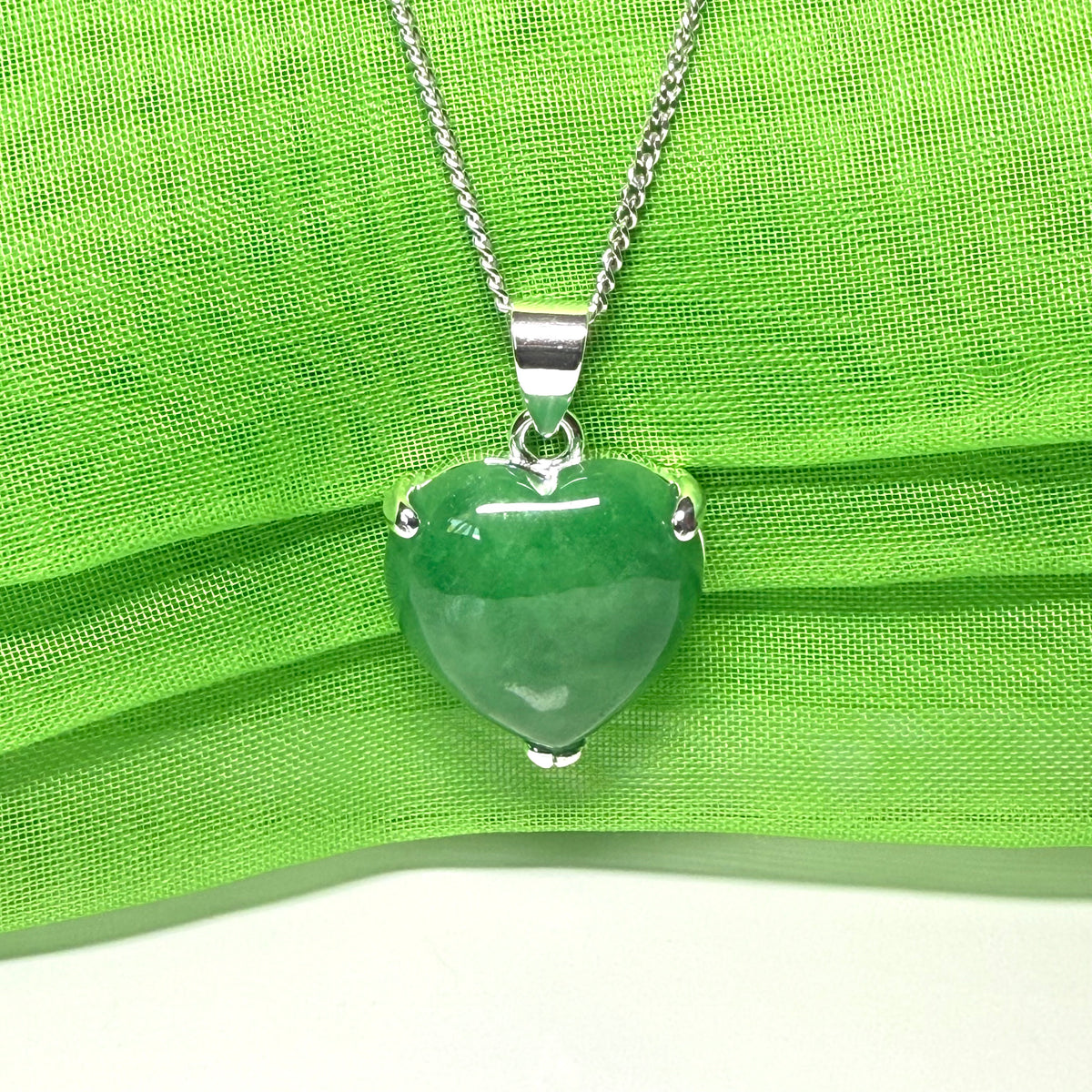 A real green jade necklace heart shape sterling silver pendant