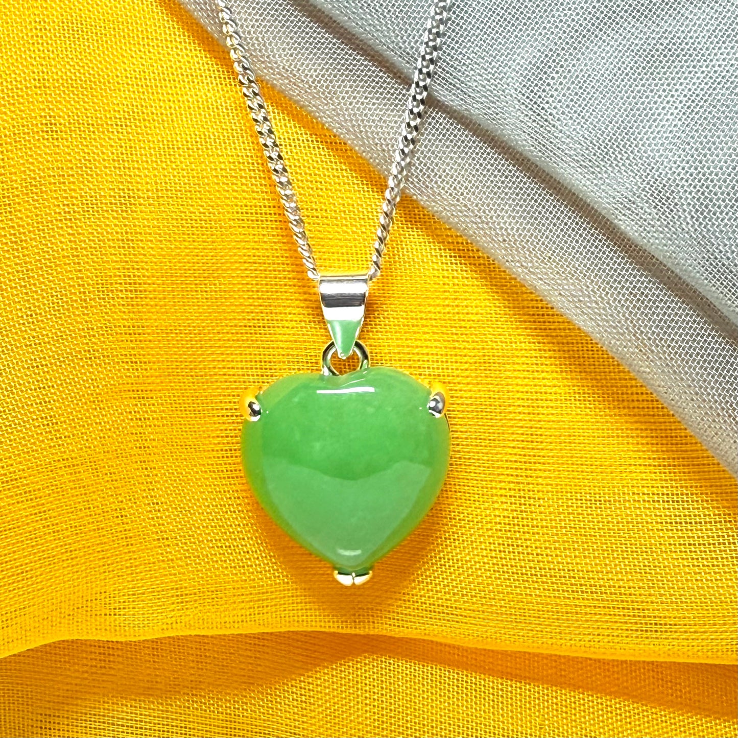 A real green jade necklace heart shaped sterling silver with chain included as well