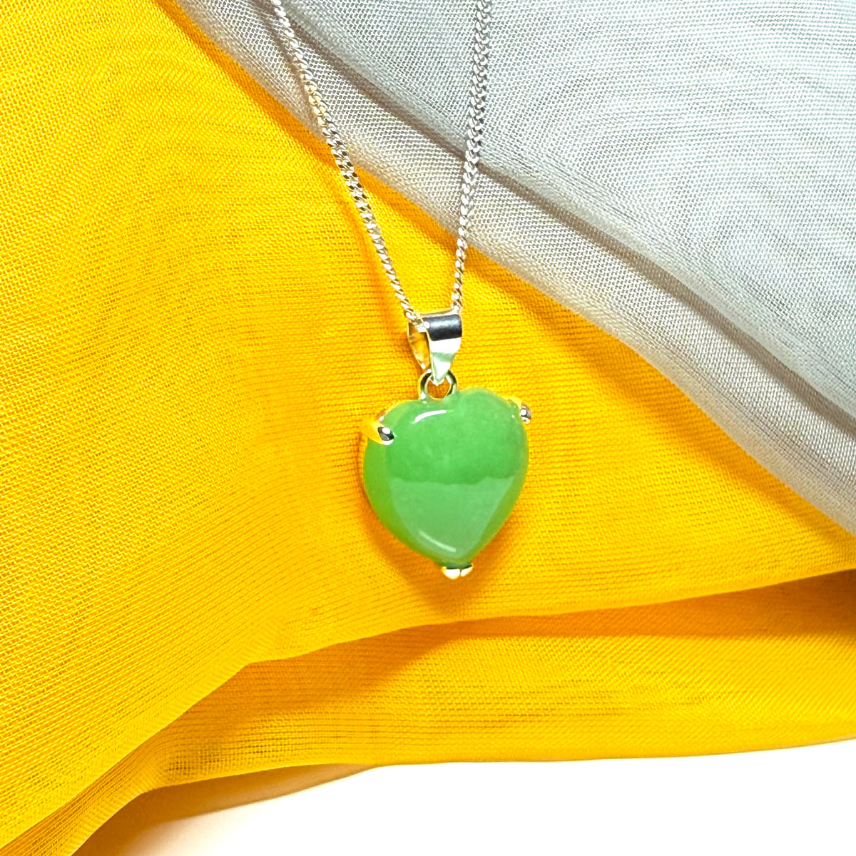 A real green jade necklace heart shaped sterling silver with chain included as well
