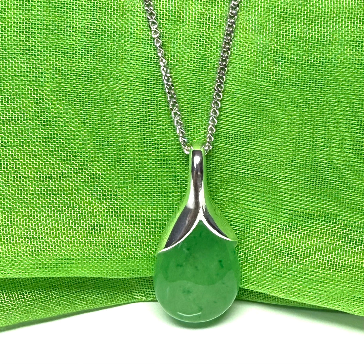 A real green jade necklace in a tear drop or pear shaped with a chain included