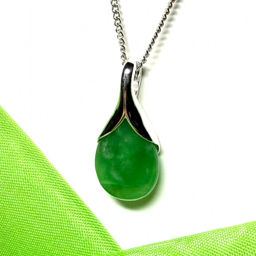 A real green jade necklace in a teardrop or a pear shape including a chain