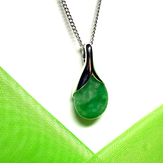 A real green jade necklace in a teardrop or a pear shape including a solid curb chain