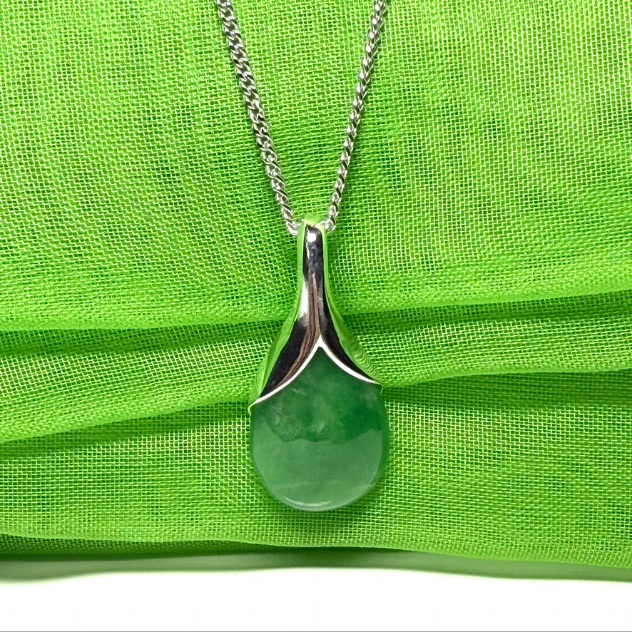 A real green jade necklace in a teardrop or a pear shape including a chain