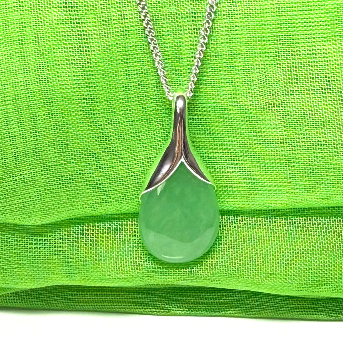 A real green jade necklace in a teardrop or pear shaped including a chain and a gift box