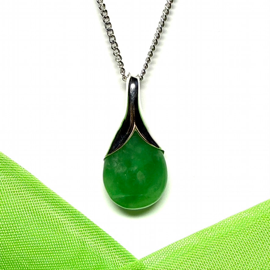 A real green jade necklace in a teardrop or a pear shape including a chain
