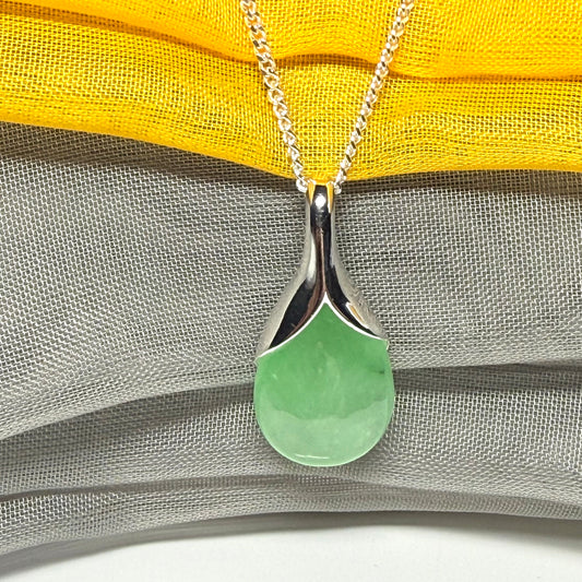 A real green jade necklace in a teardrop or pear shape, a traditional designed pendant