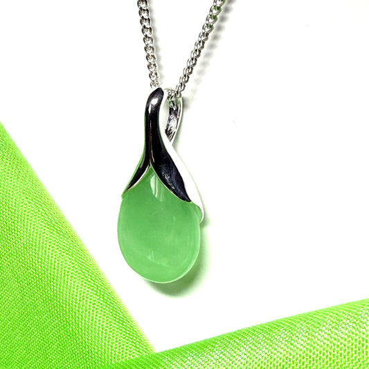 A real green jade necklace in a teardrop or pear shaped including a chain