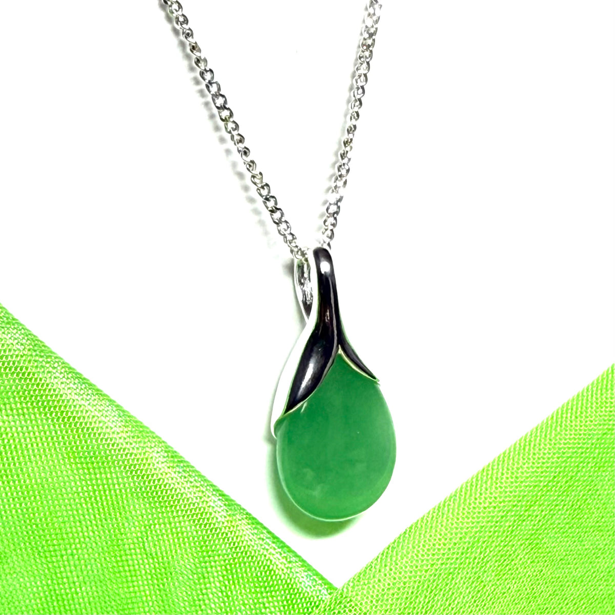 A real green jade necklace in a teardrop or pear shaped including a chain and a gift box