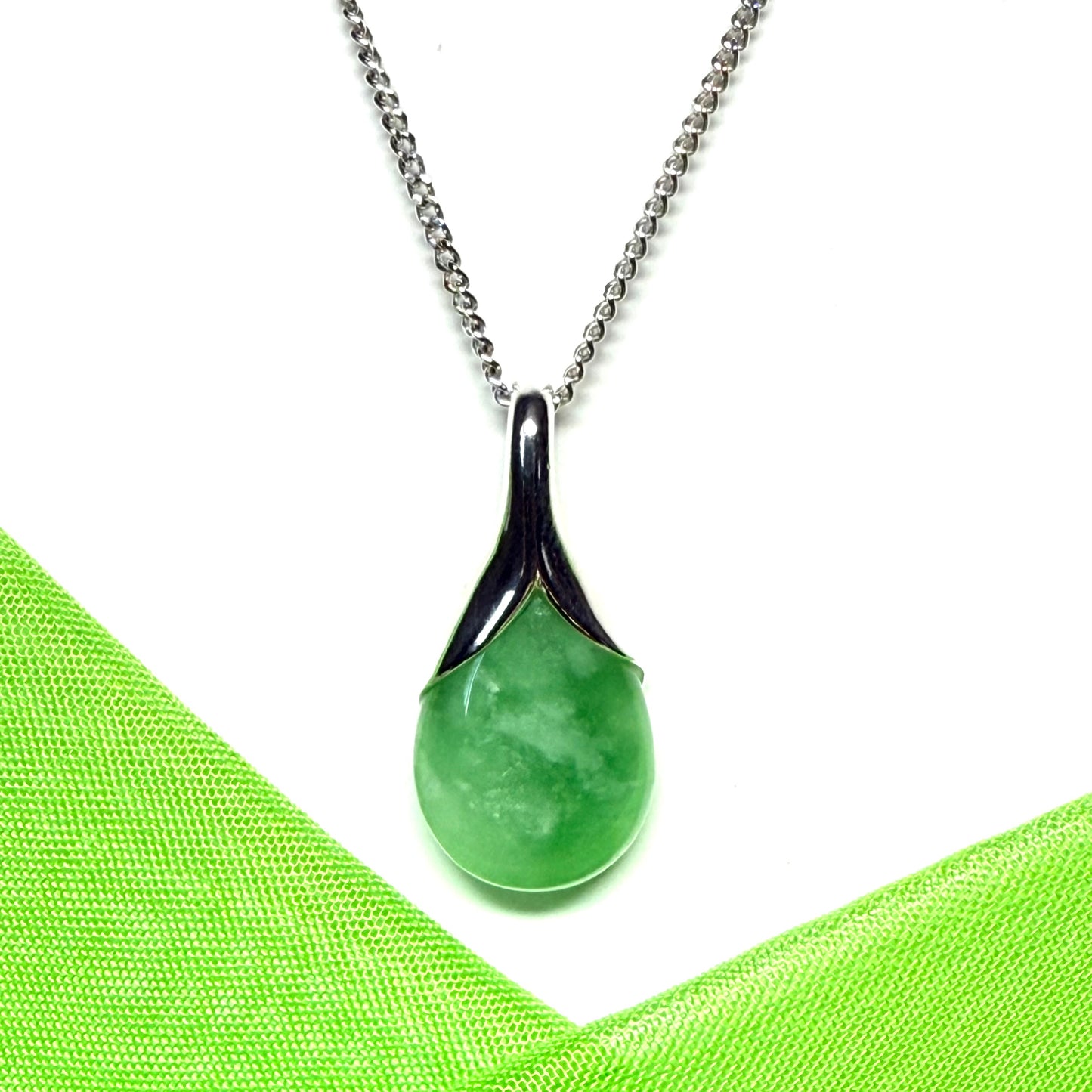 A real green jade necklace teardrop with a pear shaped pendant