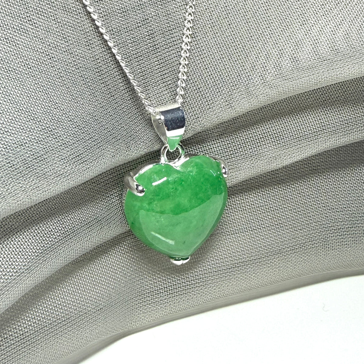 A real green jade pendant heart shape sterling silver necklace with a chain