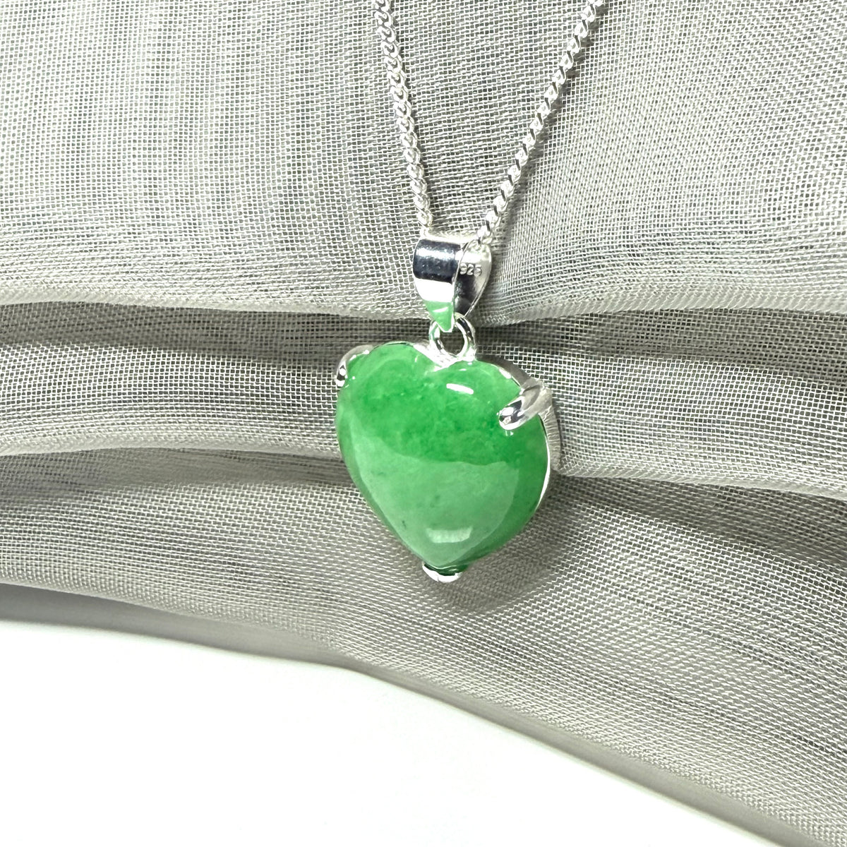 A real green jade pendant heart shape sterling silver necklace with a chain