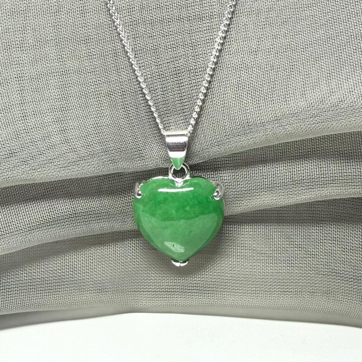A real green jade pendant heart shape sterling silver necklace with a chain