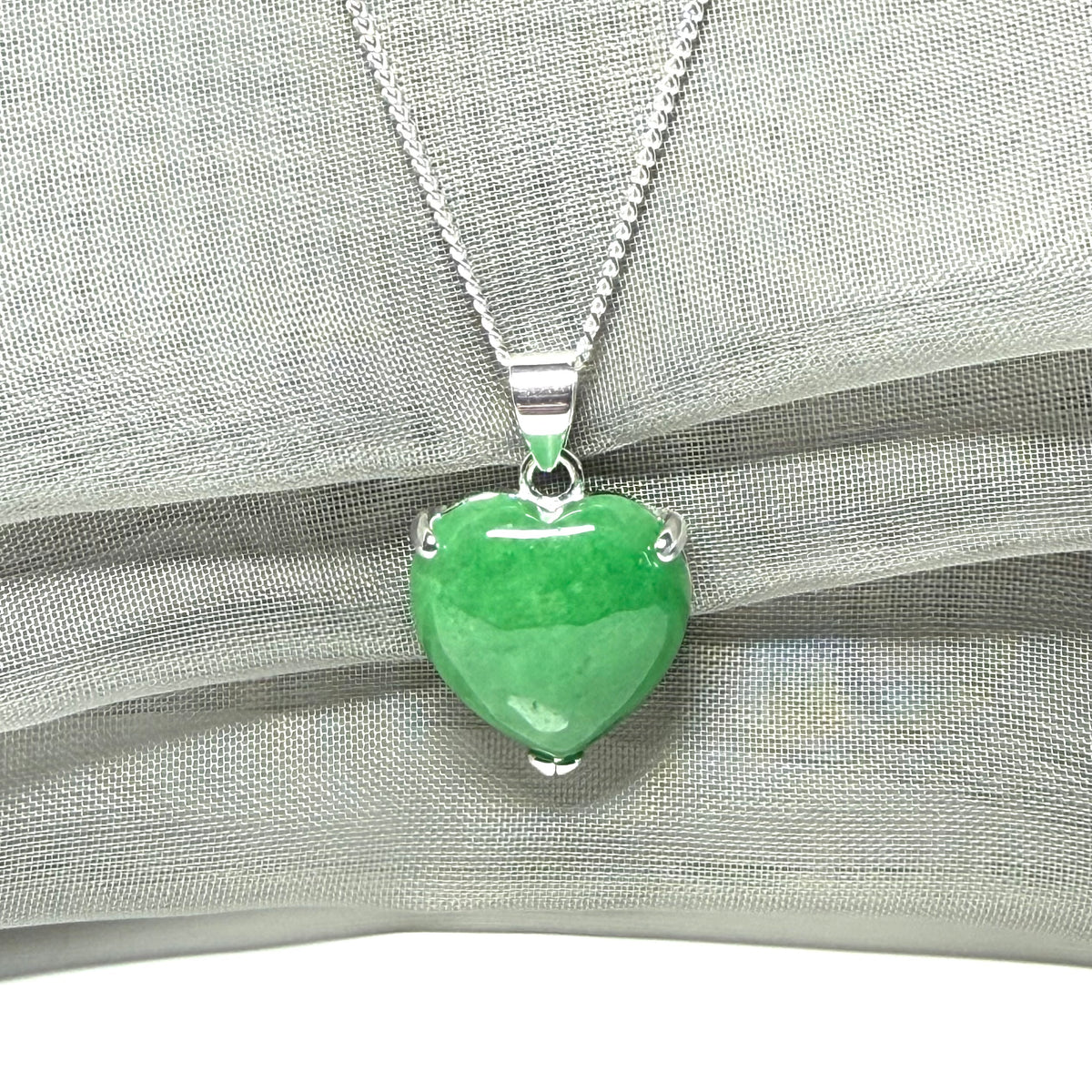 A real green jade pendant heart shape sterling silver necklace with a chain