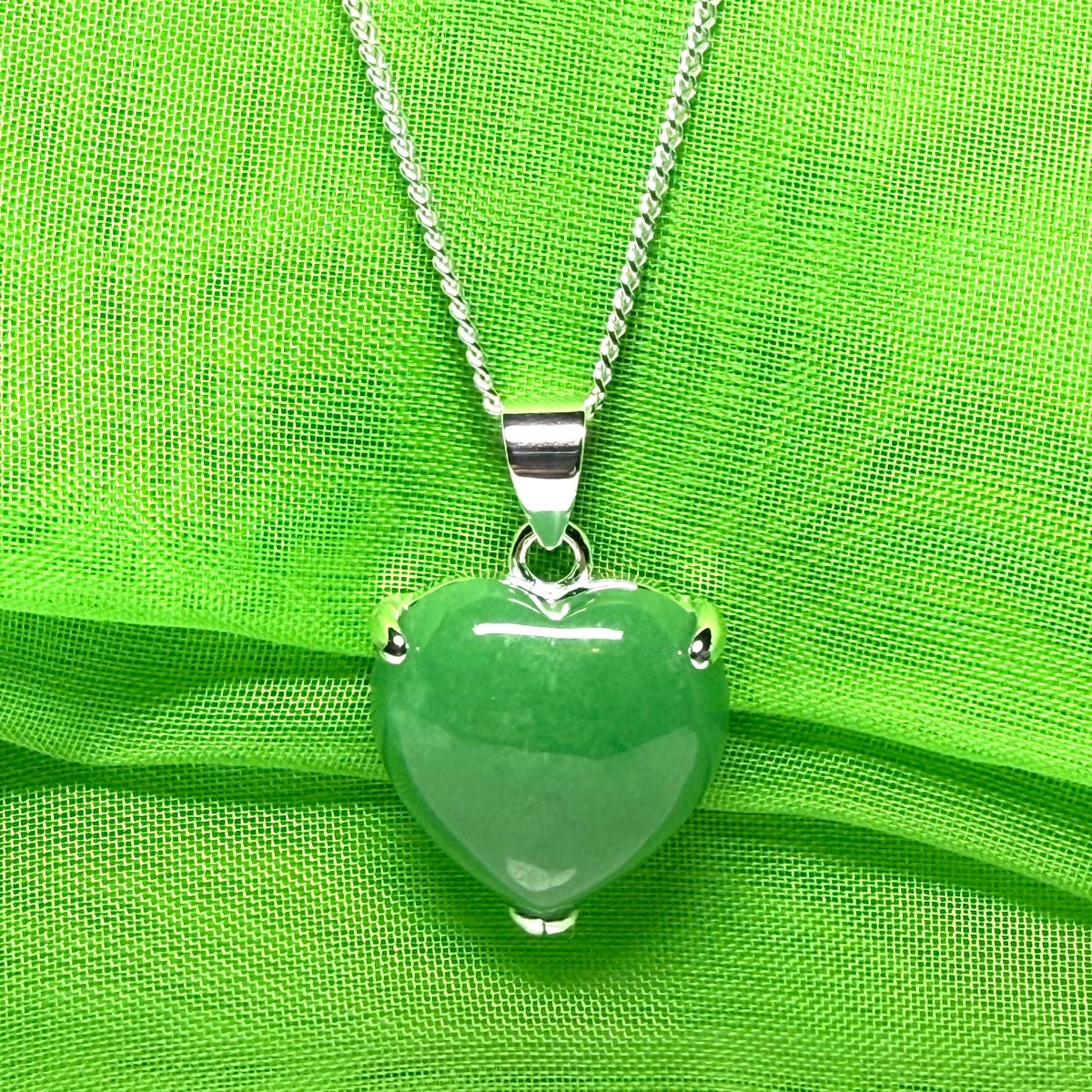 A real green jade pendant heart shaped sterling silver, a traditionally designed necklace