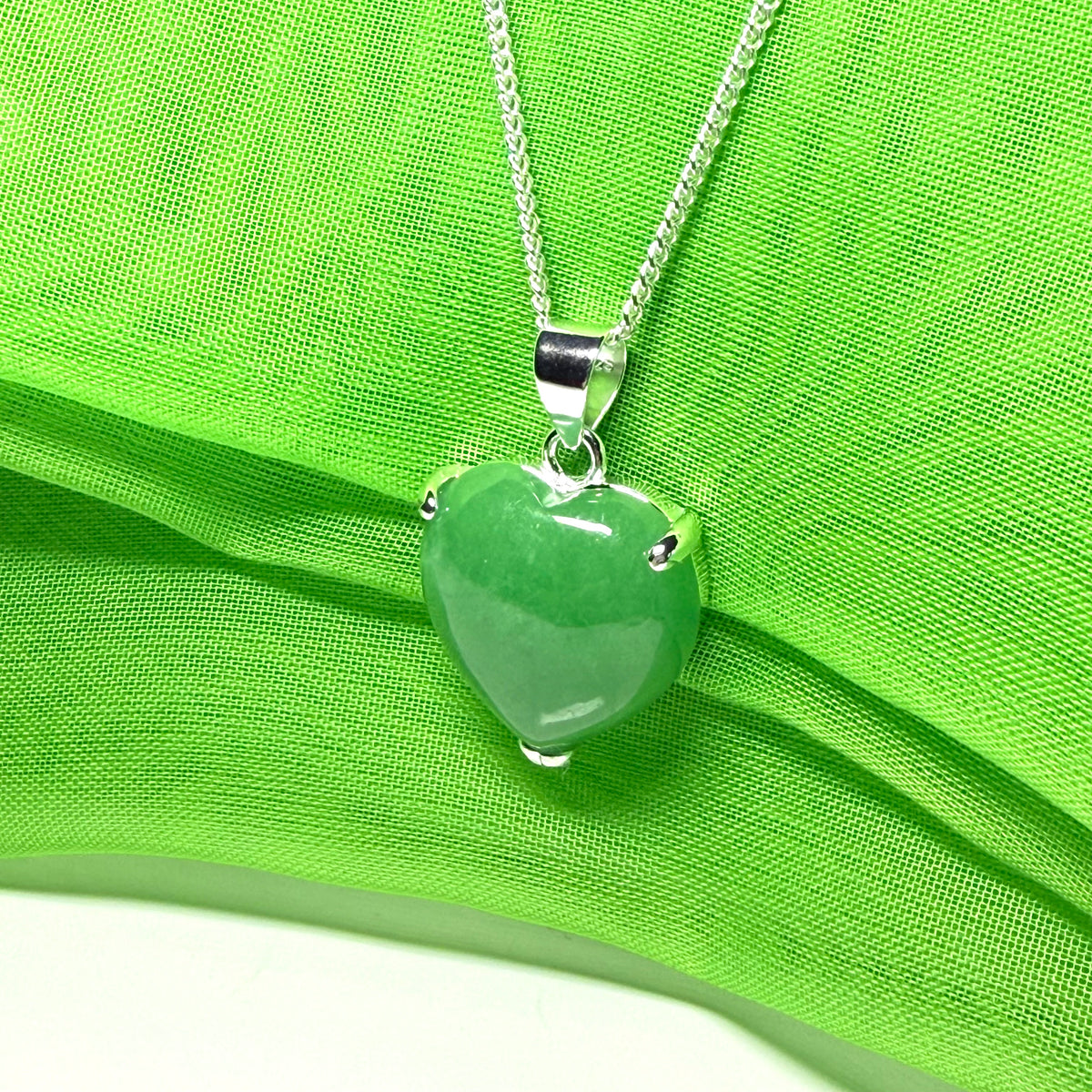 A real green jade pendant heart shaped sterling silver, a traditionally designed necklace