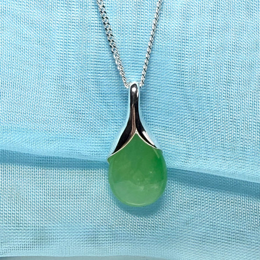A real green jade pendant necklace in a distinctive teardrop shape or pear shaped design