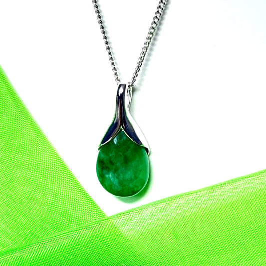 A real green jade pendant necklace in a teardrop shaped or pear shaped with a chain