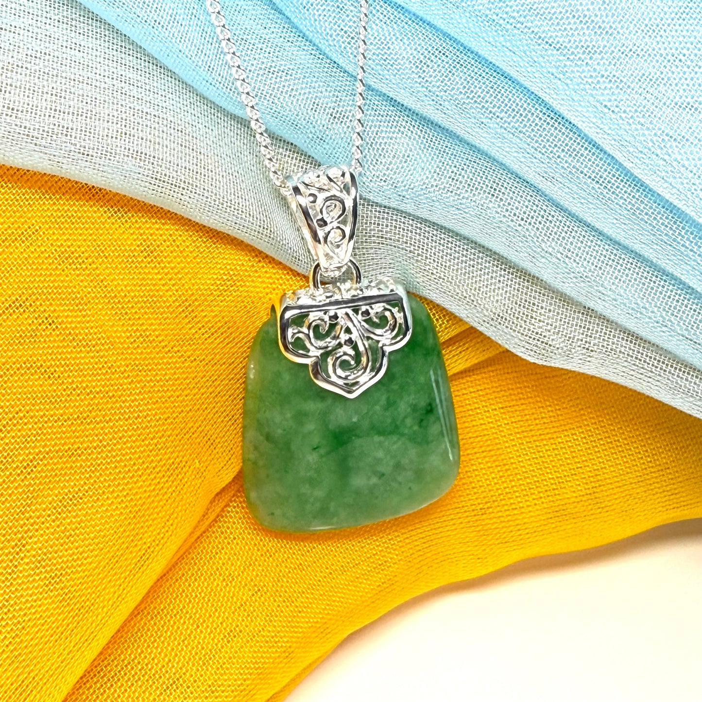 A real jade necklace green sterling silver large cushion shaped, with a beautiful designed pendant with a chain