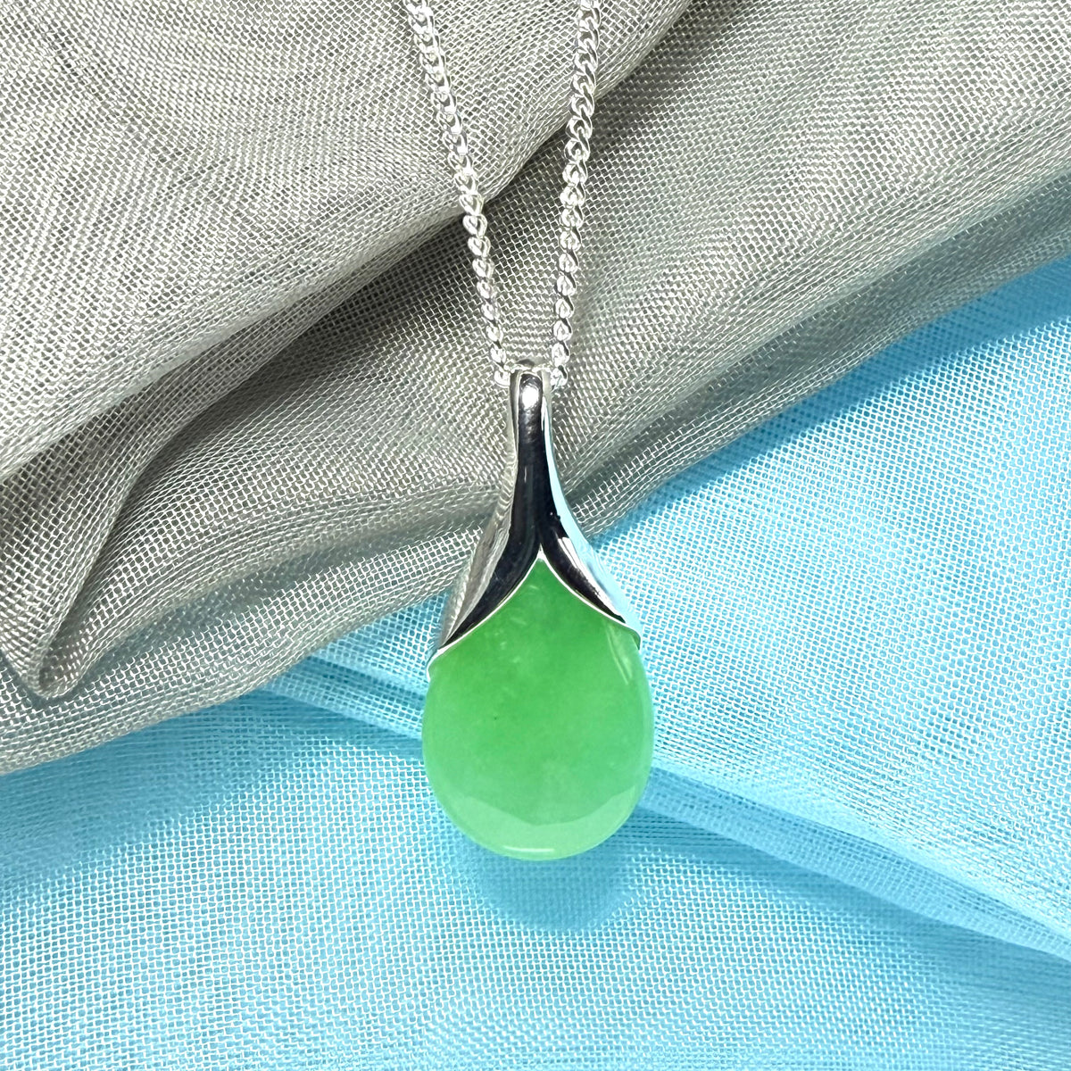 A real jade pendant in a teardrop shape or pear shaped designed green necklace