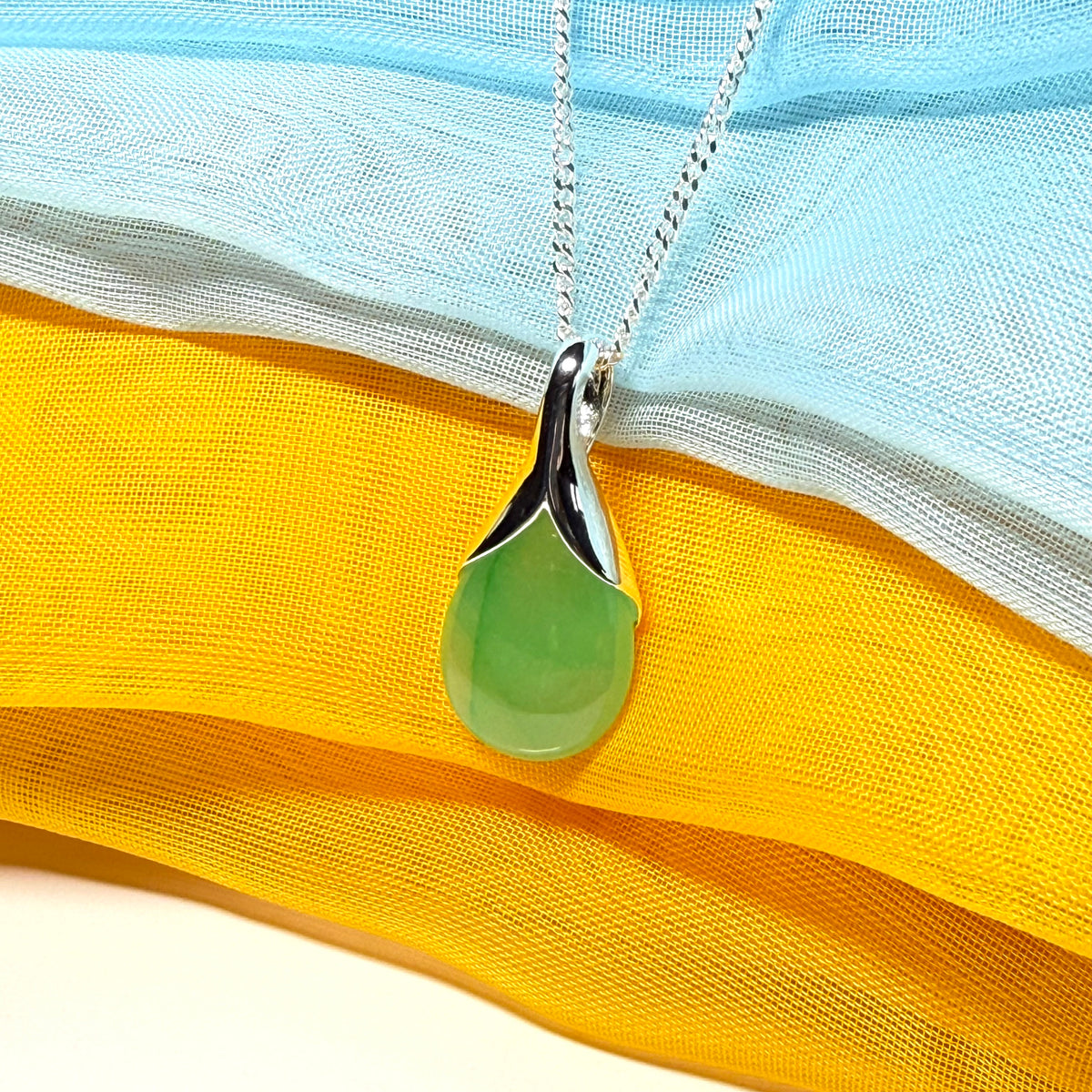 A real jade teardrop shaped designed green necklace or pear shape pendant