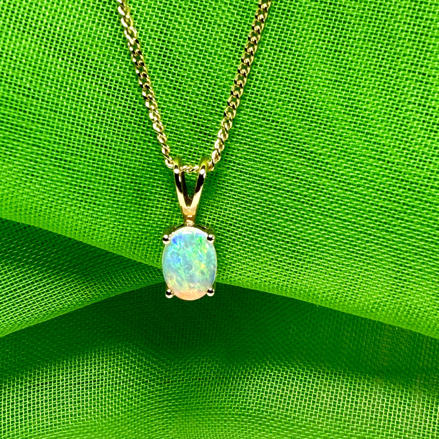 Real opal pendant oval cut yellow gold