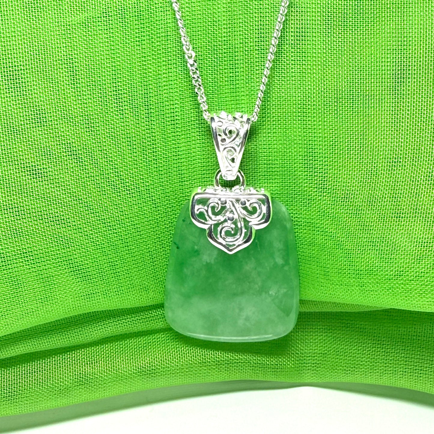 A beautiful and stunning real green jade necklace large pendant that is cushion shaped