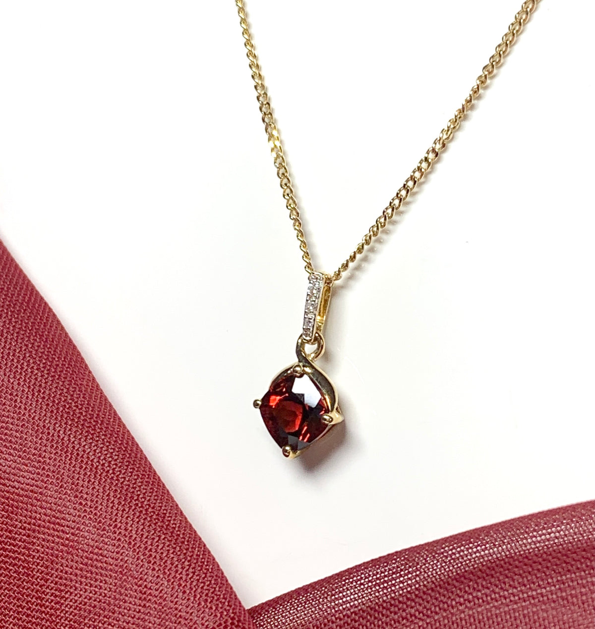 A red brown real garnet and diamond necklace yellow gold cushion shaped pendant