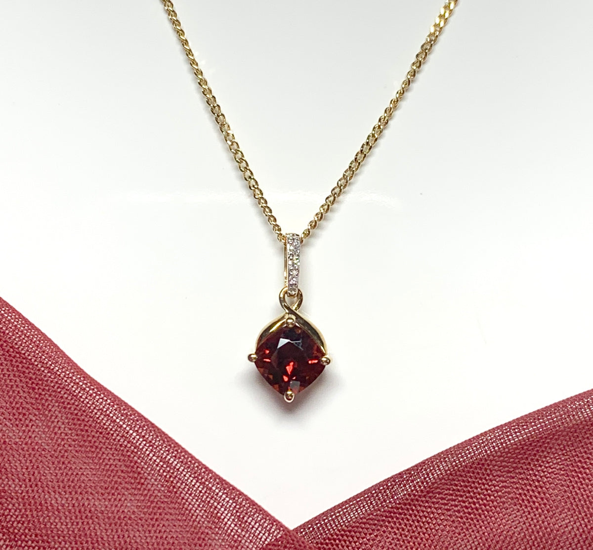 A red brown real garnet and diamond necklace yellow gold cushion shaped pendant
