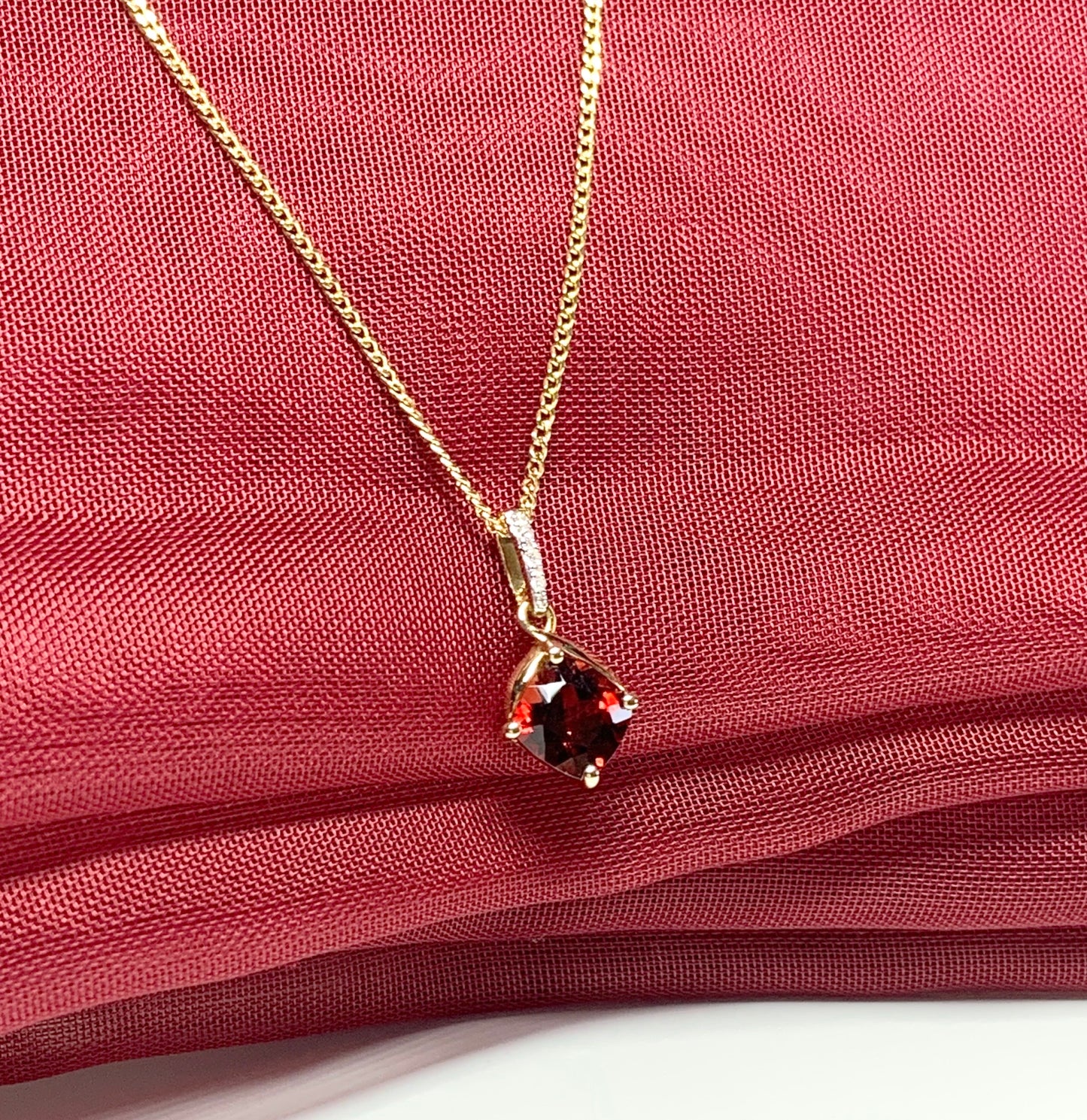 A red brown real garnet and diamond necklace yellow gold cushion shaped pendant