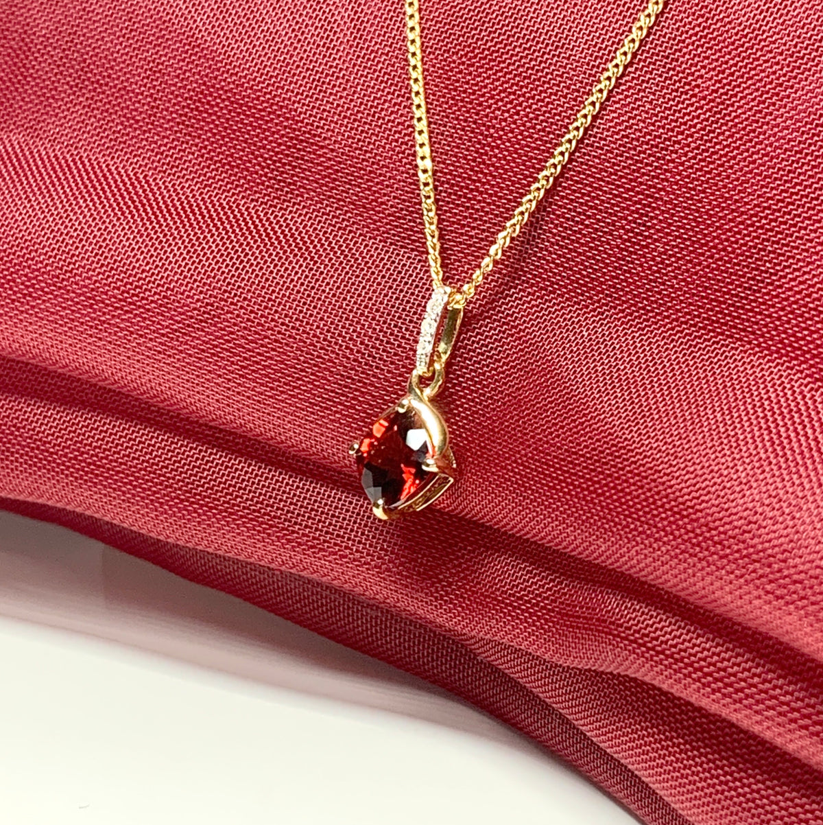 A red brown real garnet and diamond necklace yellow gold cushion shaped pendant